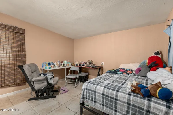 a bedroom with a bed and chair