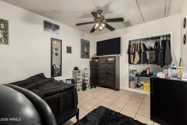 a bedroom with a bed and a flat screen tv