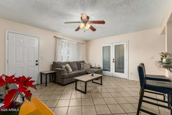 a living room with furniture and a chandelier