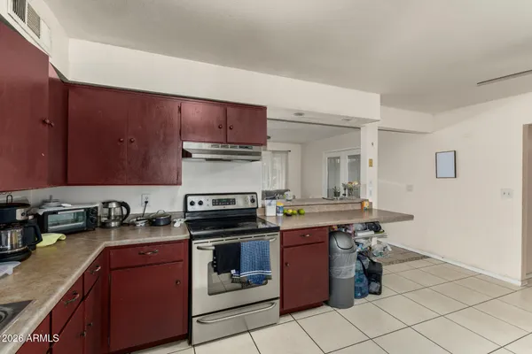 a kitchen with stainless steel appliances a stove top oven and cabinets