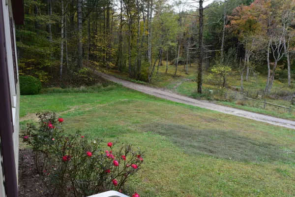 a view of empty room with a fireplace and fan