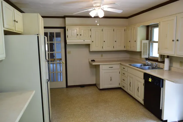 a kitchen with a sink and large window