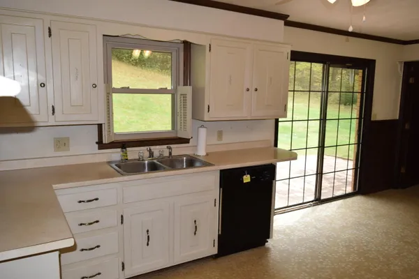 a kitchen with stainless steel appliances a refrigerator and cabinets