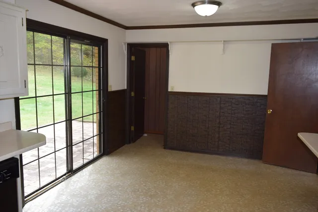 a bathroom with a toilet a sink and a window