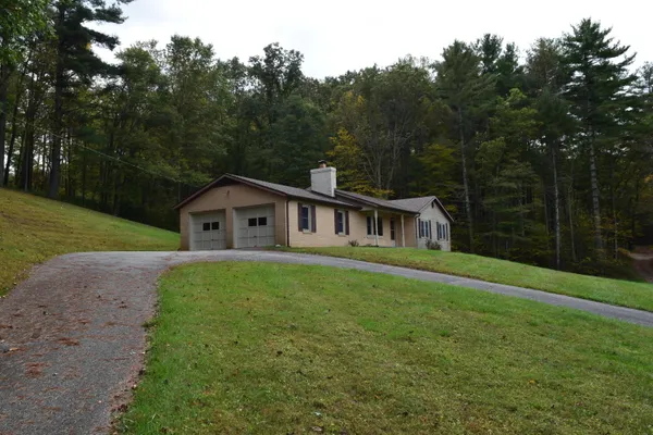 a house with green field in front of it
