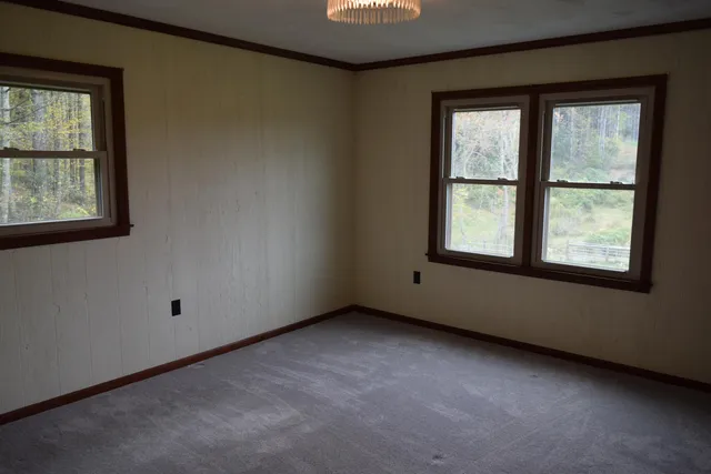 a view of an empty room with wooden door