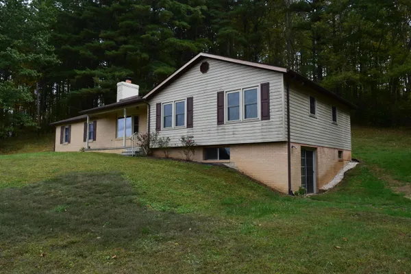 a front view of house with yard and green space