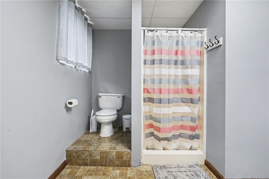 7388 Post Road Winston, GA 30187 - Photo 12 of 32 a bathroom with a toilet and a shower curtain