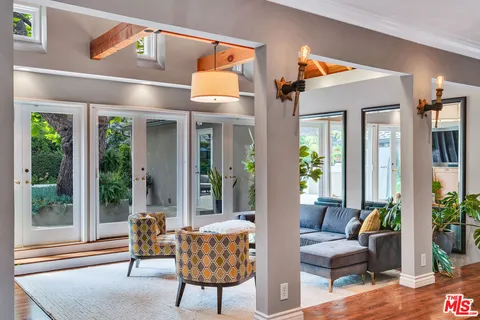 a kitchen with white cabinets and appliances