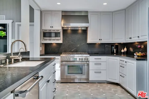 a bedroom with a bed and a large mirror