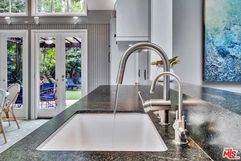 a bathroom with double vanity and a mirror