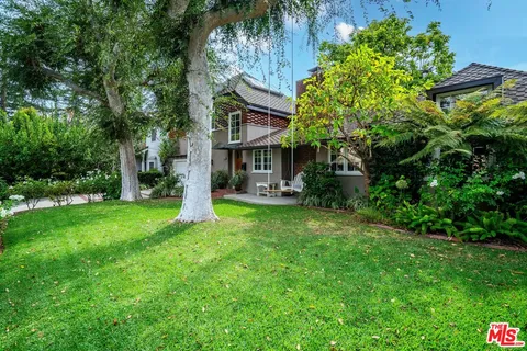 a living room with furniture a table and wooden floor