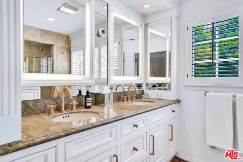 a view of a patio with table and chairs potted plants and floor to ceiling window