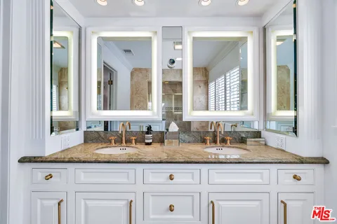 a patio with table and chairs and potted plants