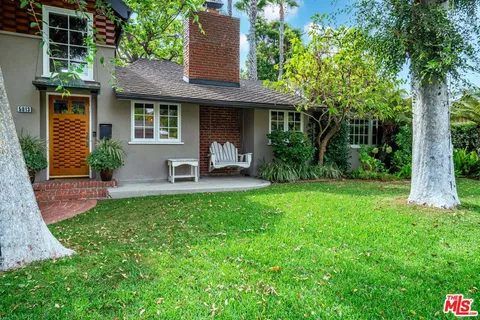 a living room with furniture a wooden floor and next to a window