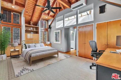 a view of a house with backyard and a sitting area