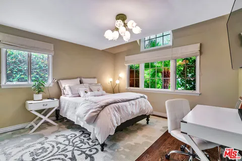 a swimming pool view with a seating space and a garden view