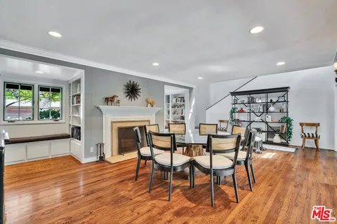 a living room with furniture white walls and kitchen view