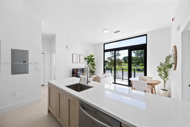 a kitchen with a sink and living room