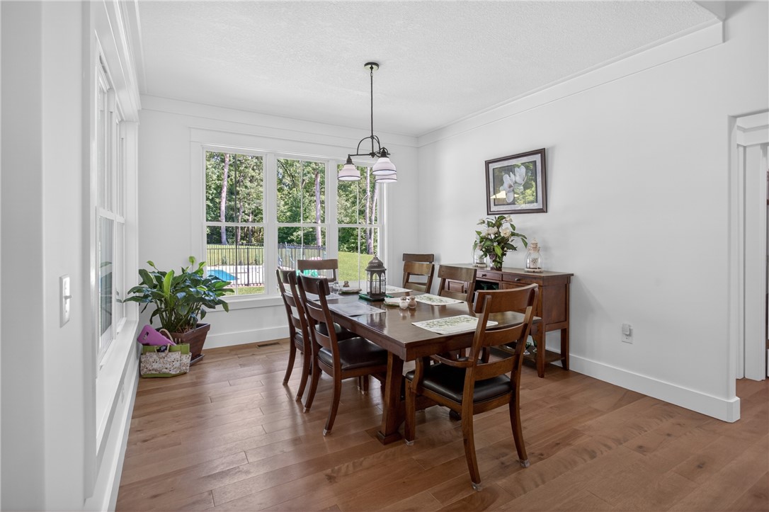 921 Falling Waters Lane Seneca, SC 29672 - Photo 18 of 46 Hardwood floors and generous natural light elevate this inviting dining room, perfect for gatherings.