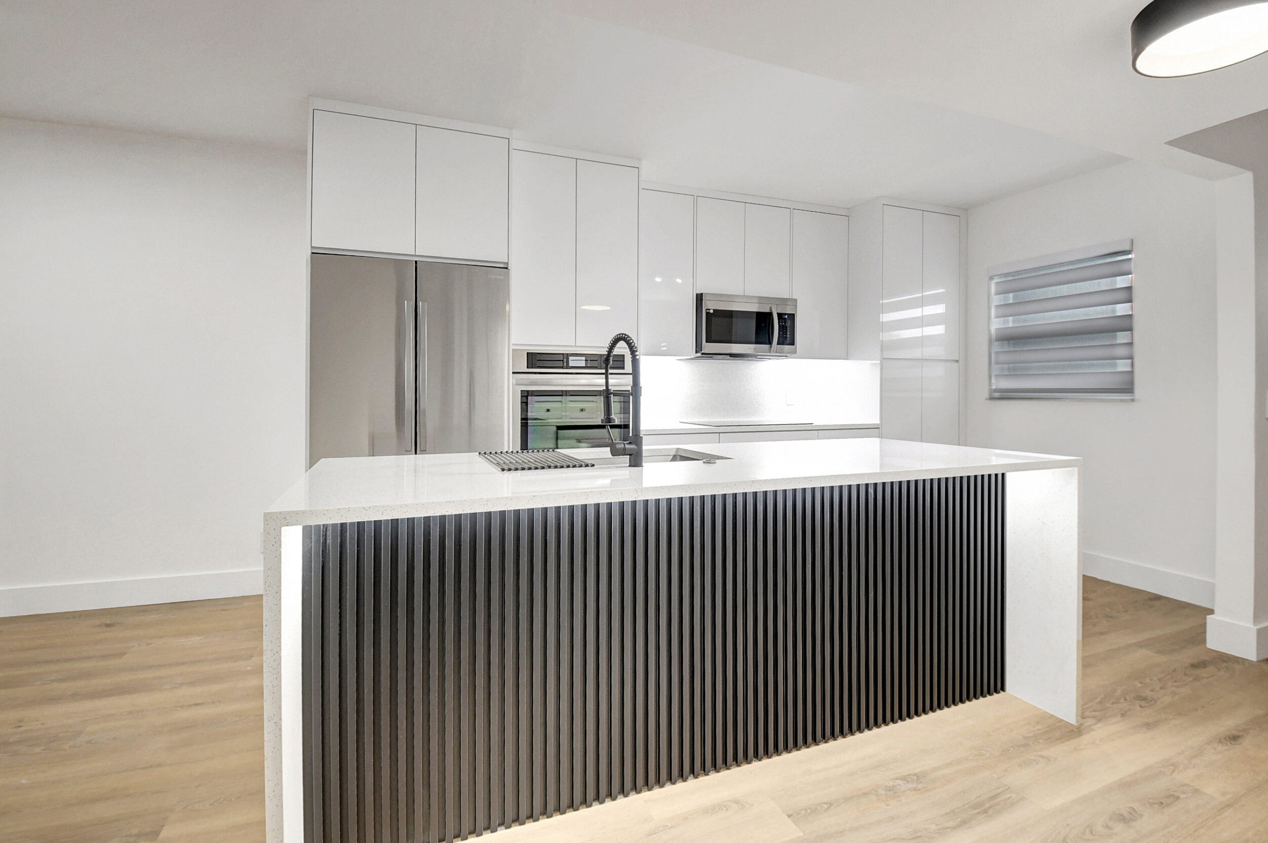 a kitchen with stainless steel appliances a refrigerator and microwave