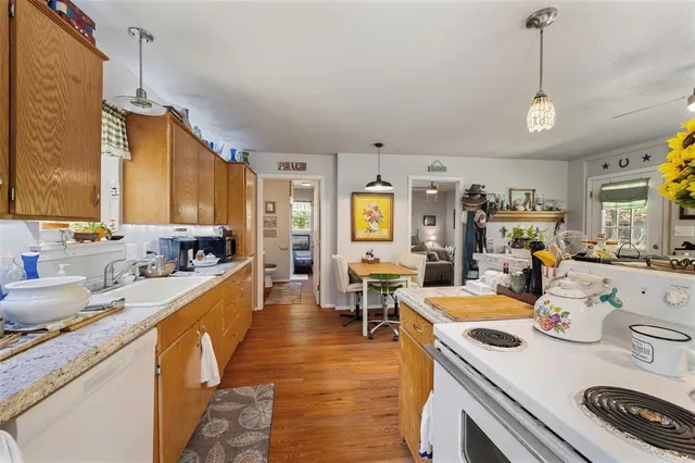 a large kitchen with kitchen island a stove a sink a dining table and chairs