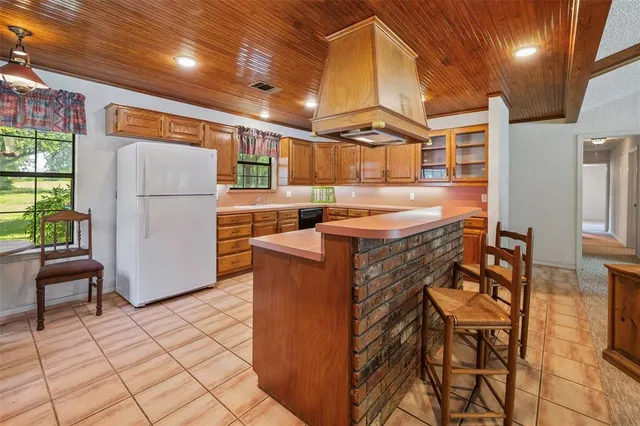 a kitchen with stainless steel appliances granite countertop a sink and a refrigerator