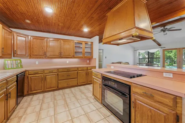 a kitchen with a stove sink and cabinets