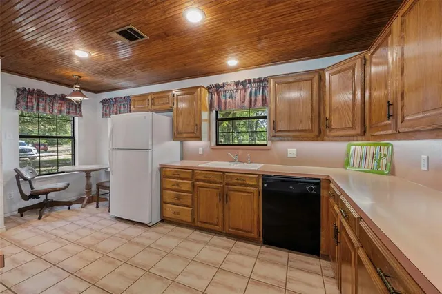 a kitchen with refrigerator cabinets and a sink