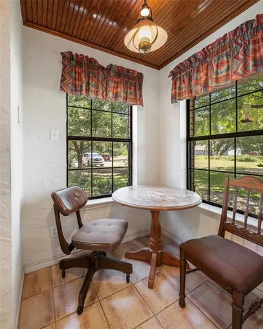 a view of a dining room with furniture a chandelier and wooden floor