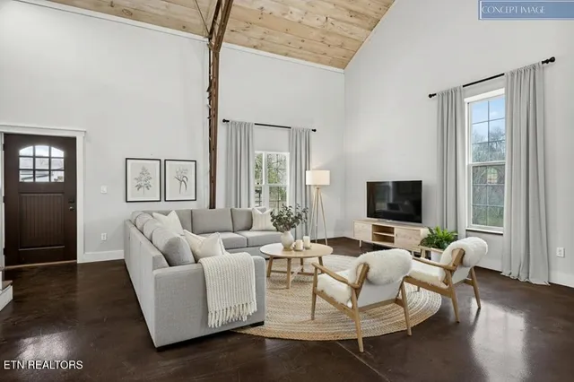 a living room with furniture wooden floor and a flat screen tv