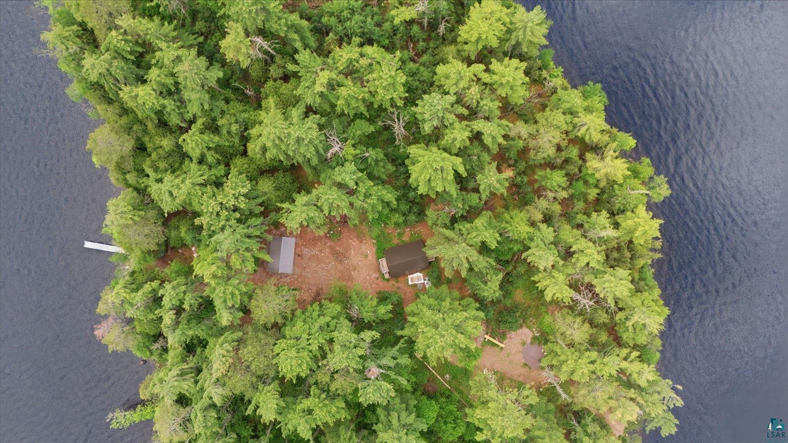 5298 Long Island Tower, MN 55790 - Photo 29 of 31 Island property featuring a main structure, an additional building, a private dock, and extensive tree coverage, surrounded by water