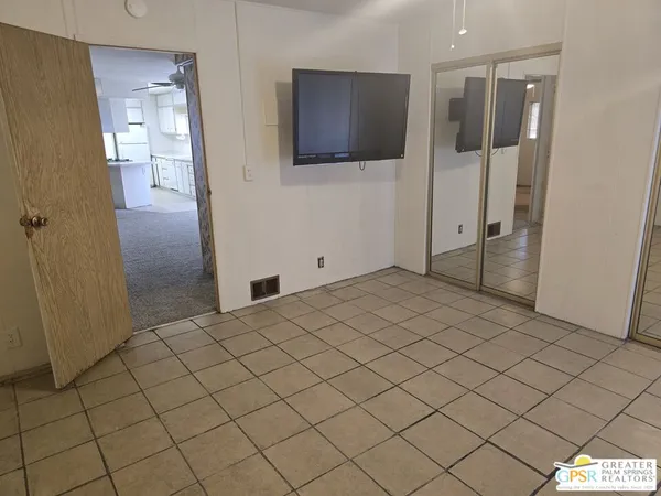 a bedroom with a bed and a view of bathroom
