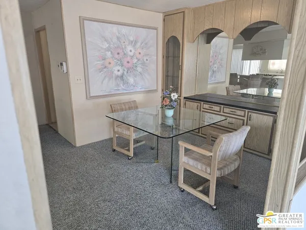 a dining room with furniture and a chandelier