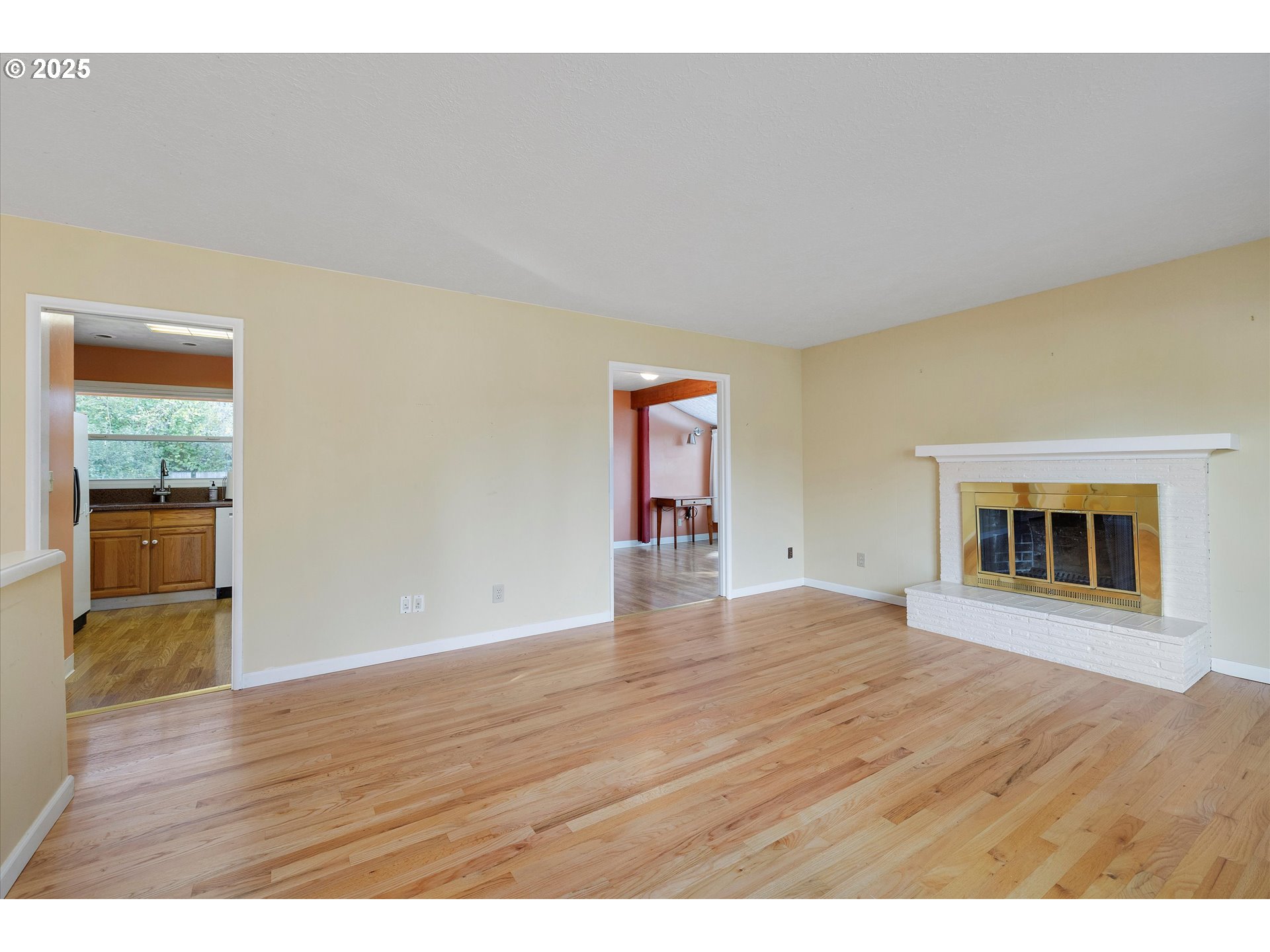 1360 Northwest 130th Avenue Portland, OR 97229 - Photo 11 of 36 a view of an empty room with wooden floor and a window