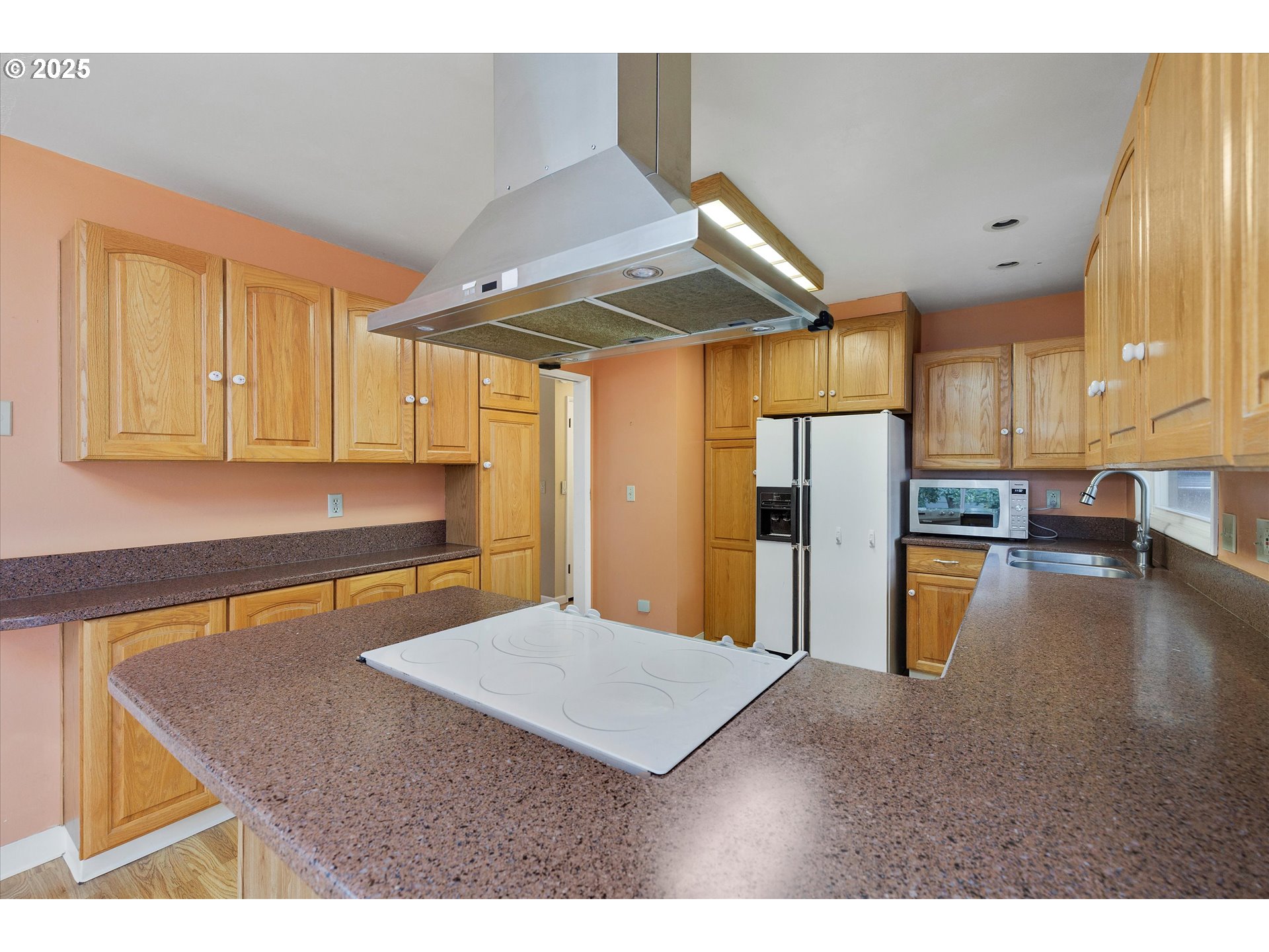 1360 Northwest 130th Avenue Portland, OR 97229 - Photo 15 of 36 a kitchen with stainless steel appliances granite countertop a sink a stove and refrigerator