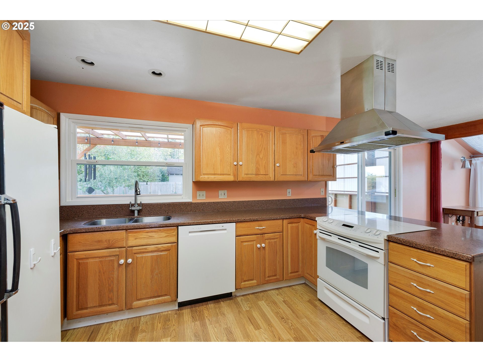 1360 Northwest 130th Avenue Portland, OR 97229 - Photo 16 of 36 a kitchen with stainless steel appliances granite countertop a stove a sink and a microwave
