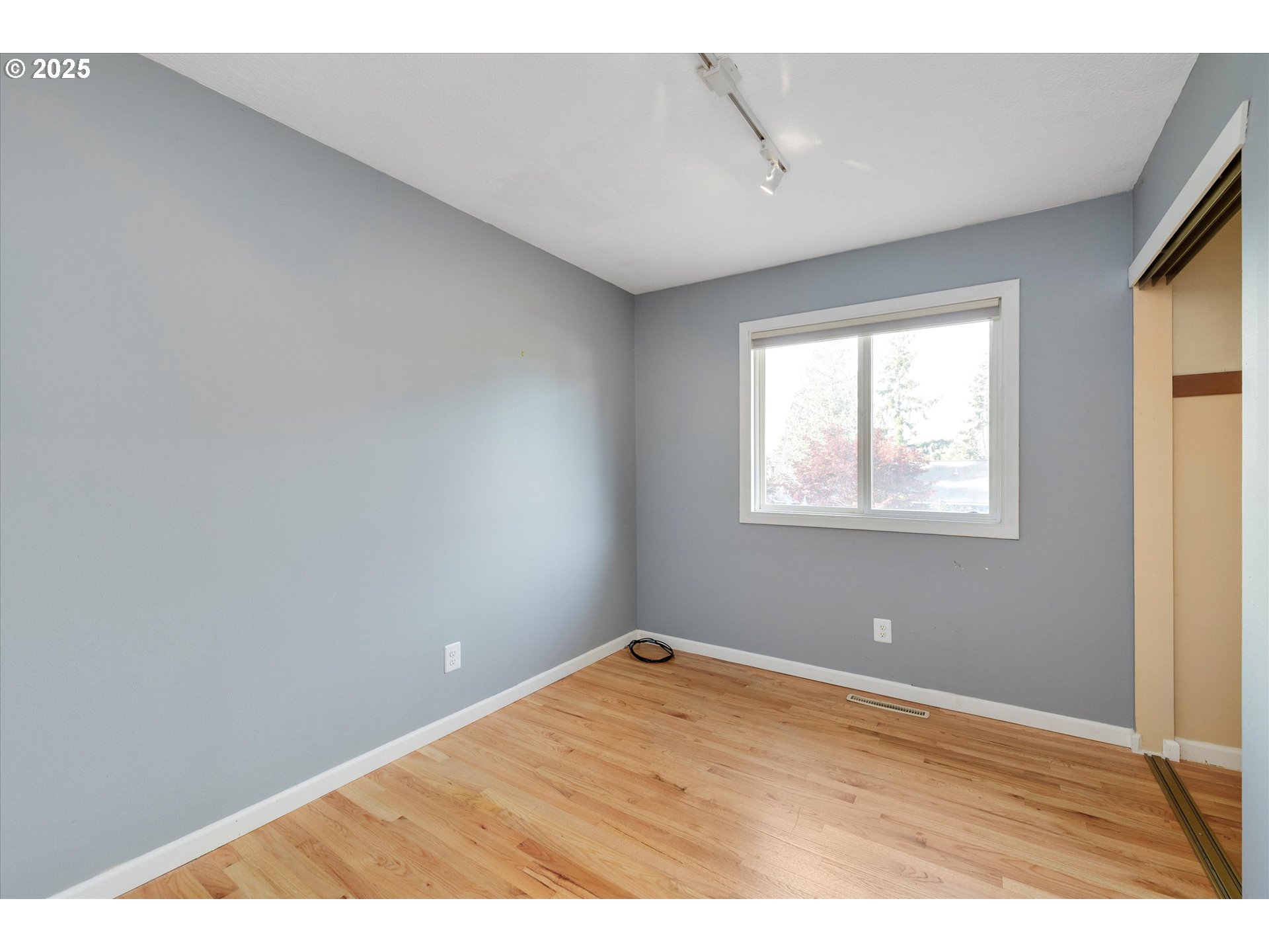 1360 Northwest 130th Avenue Portland, OR 97229 - Photo 19 of 36 a view of an empty room with wooden floor and a window