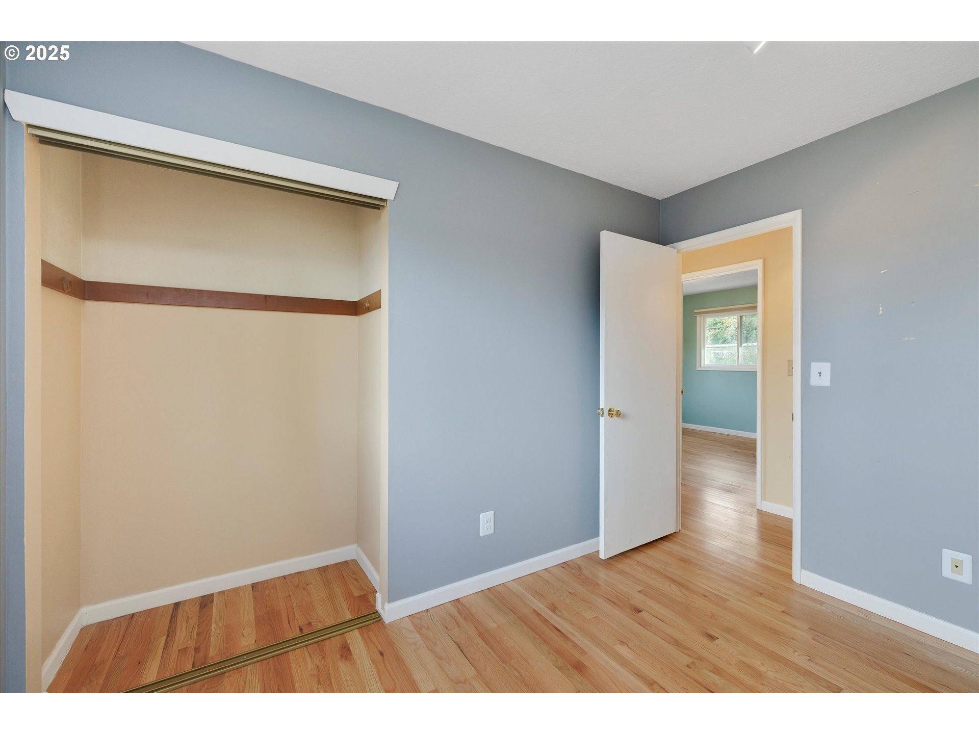 1360 Northwest 130th Avenue Portland, OR 97229 - Photo 20 of 36 a view of an empty room with wooden floor and a window