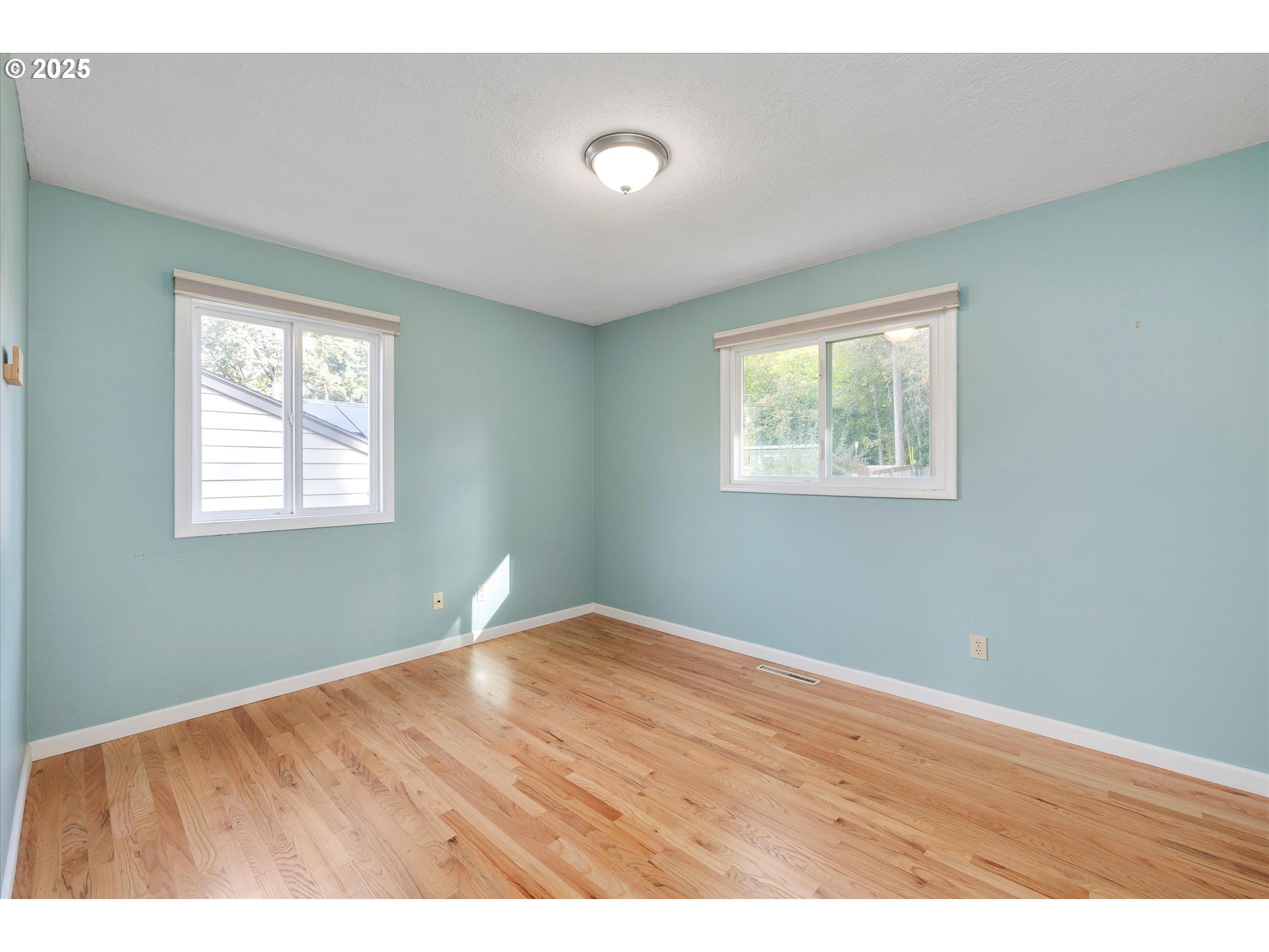 1360 Northwest 130th Avenue Portland, OR 97229 - Photo 21 of 36 a view of an empty room with wooden floor and a window