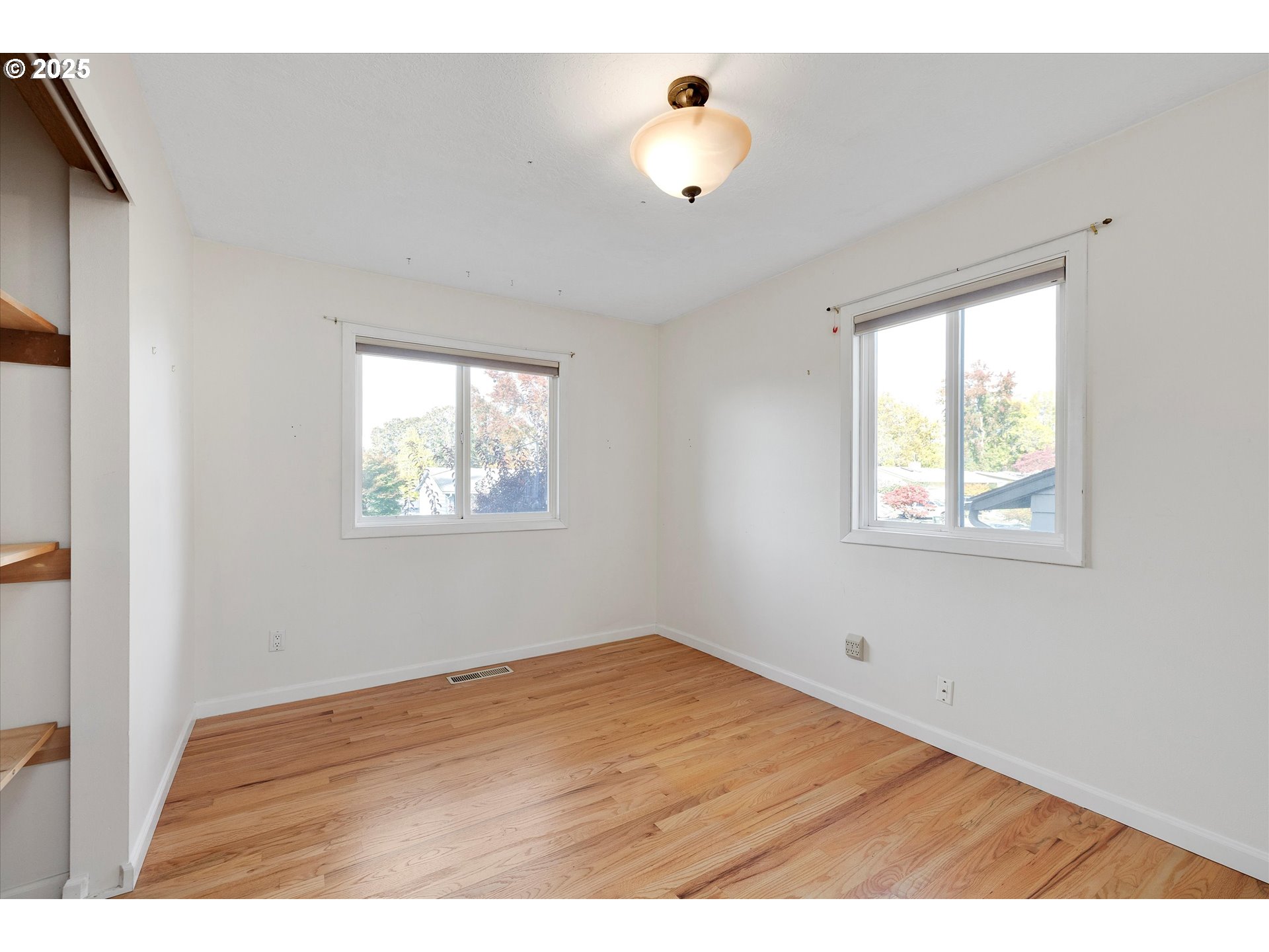 1360 Northwest 130th Avenue Portland, OR 97229 - Photo 24 of 36 a view of an empty room with a window and wooden floor