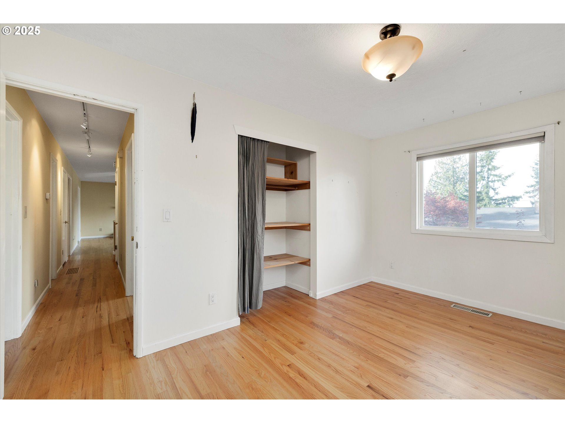 1360 Northwest 130th Avenue Portland, OR 97229 - Photo 25 of 36 a room view with wooden floor and cabinet