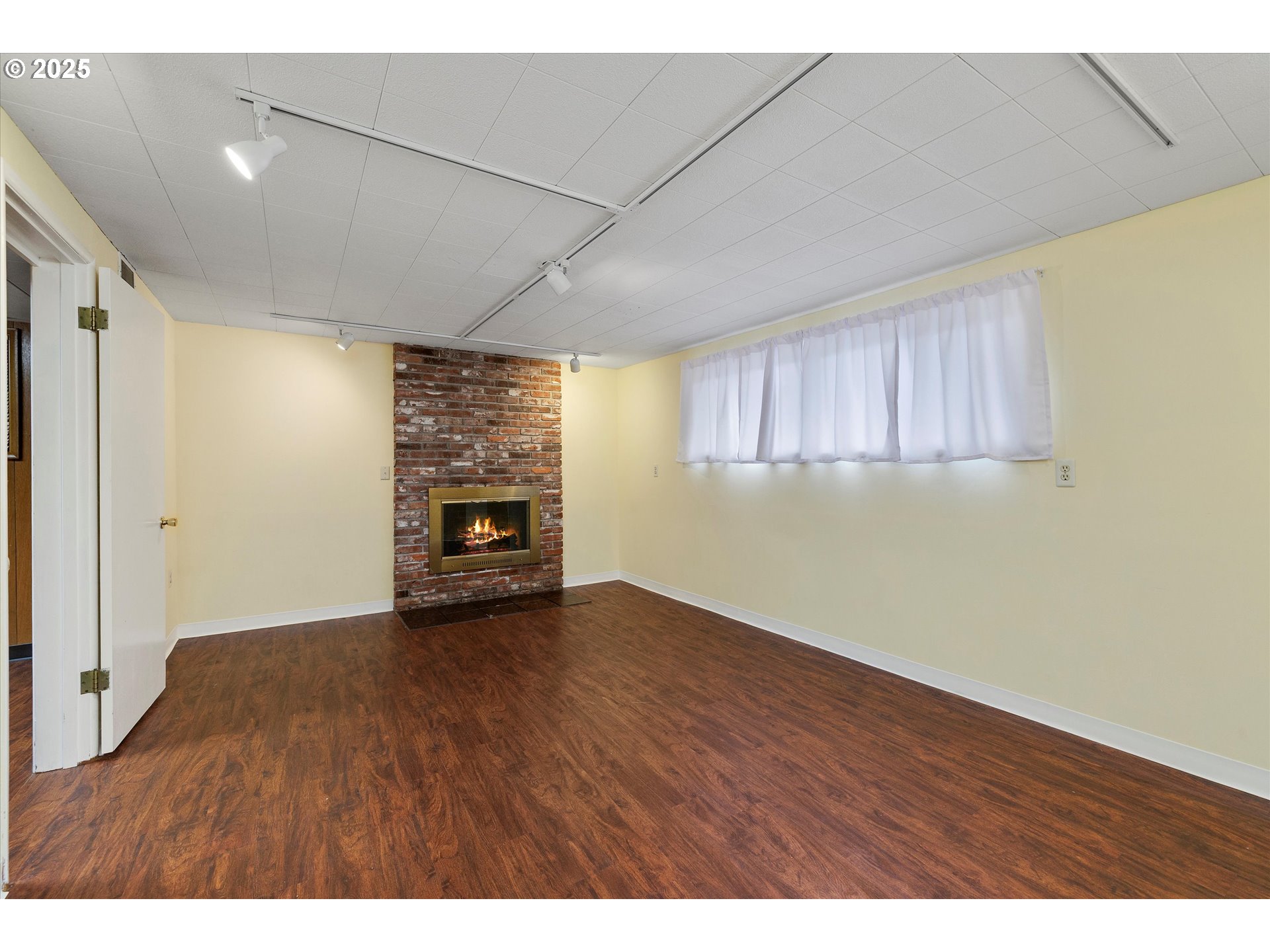 1360 Northwest 130th Avenue Portland, OR 97229 - Photo 27 of 36 a view of empty room with a fireplace and wooden floor