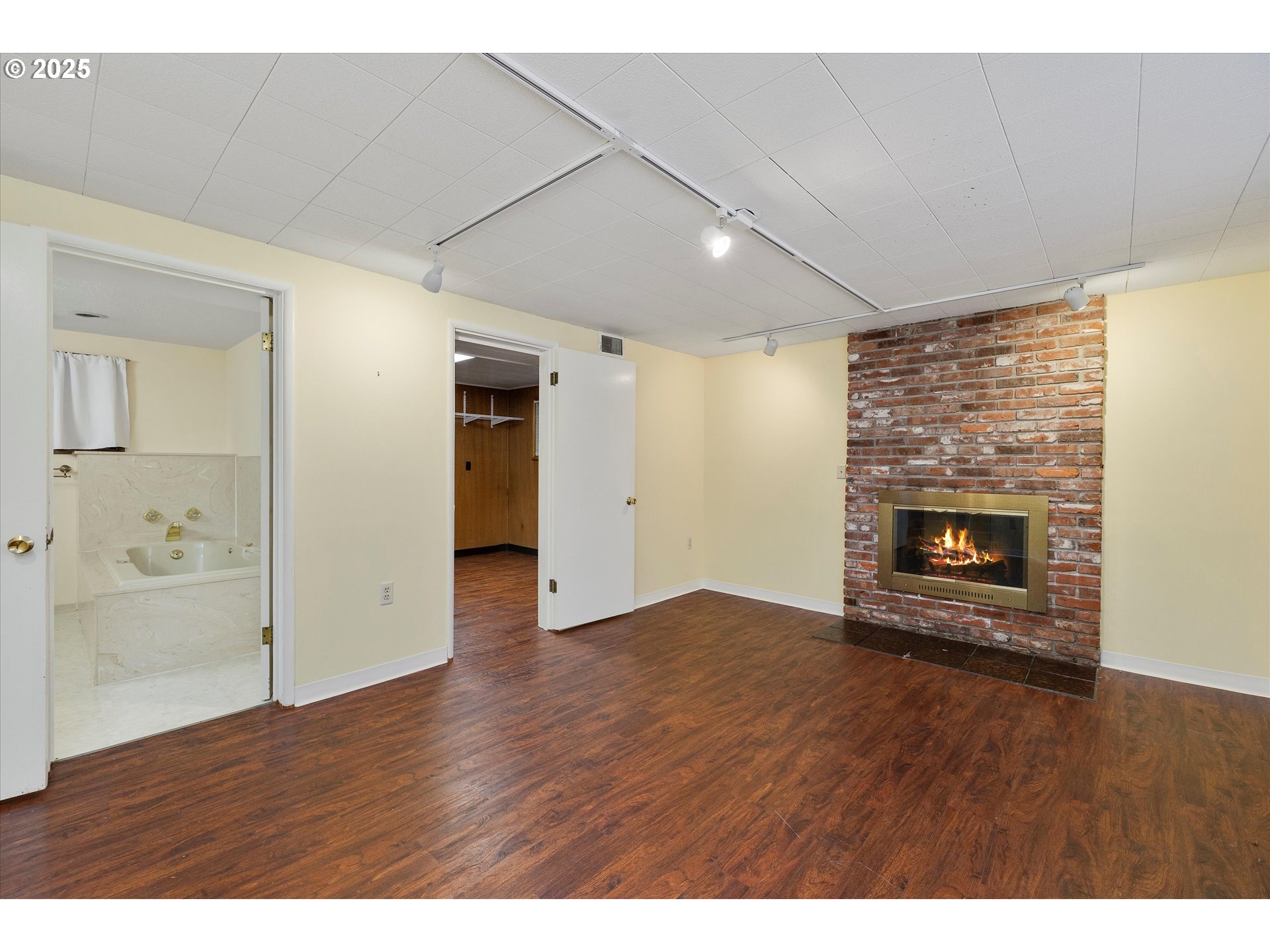1360 Northwest 130th Avenue Portland, OR 97229 - Photo 28 of 36 a view of an empty room with wooden floor fireplace and a window
