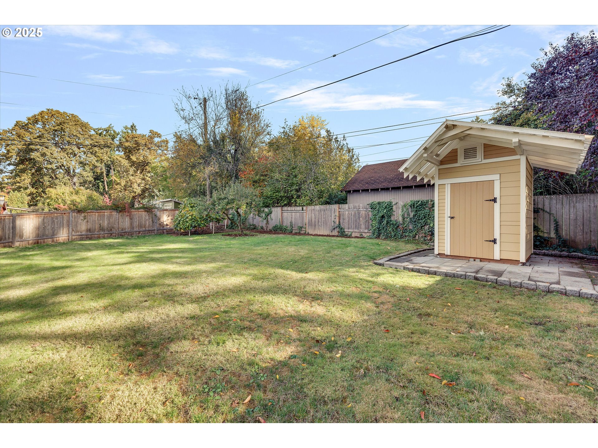 1360 Northwest 130th Avenue Portland, OR 97229 - Photo 34 of 36 a view of a white house next to a yard with big trees
