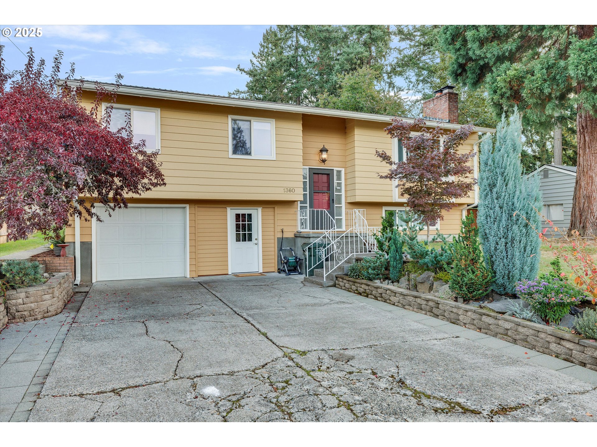 1360 Northwest 130th Avenue Portland, OR 97229 - Photo 7 of 36 a front view of a house with a yard and a garage