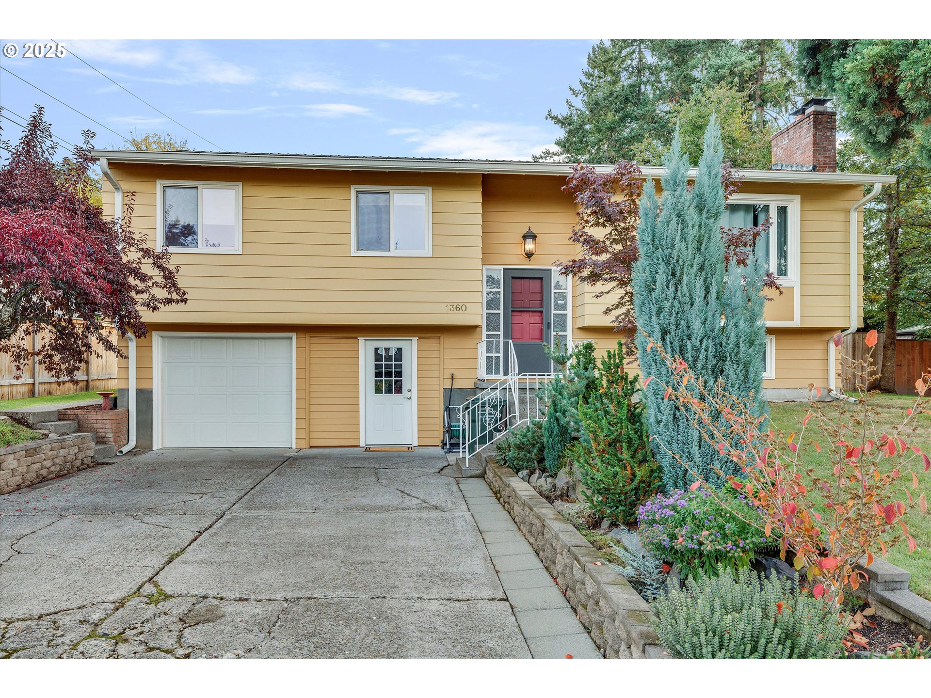 1360 Northwest 130th Avenue Portland, OR 97229 - Photo 8 of 36 a front view of a house with a yard and garage