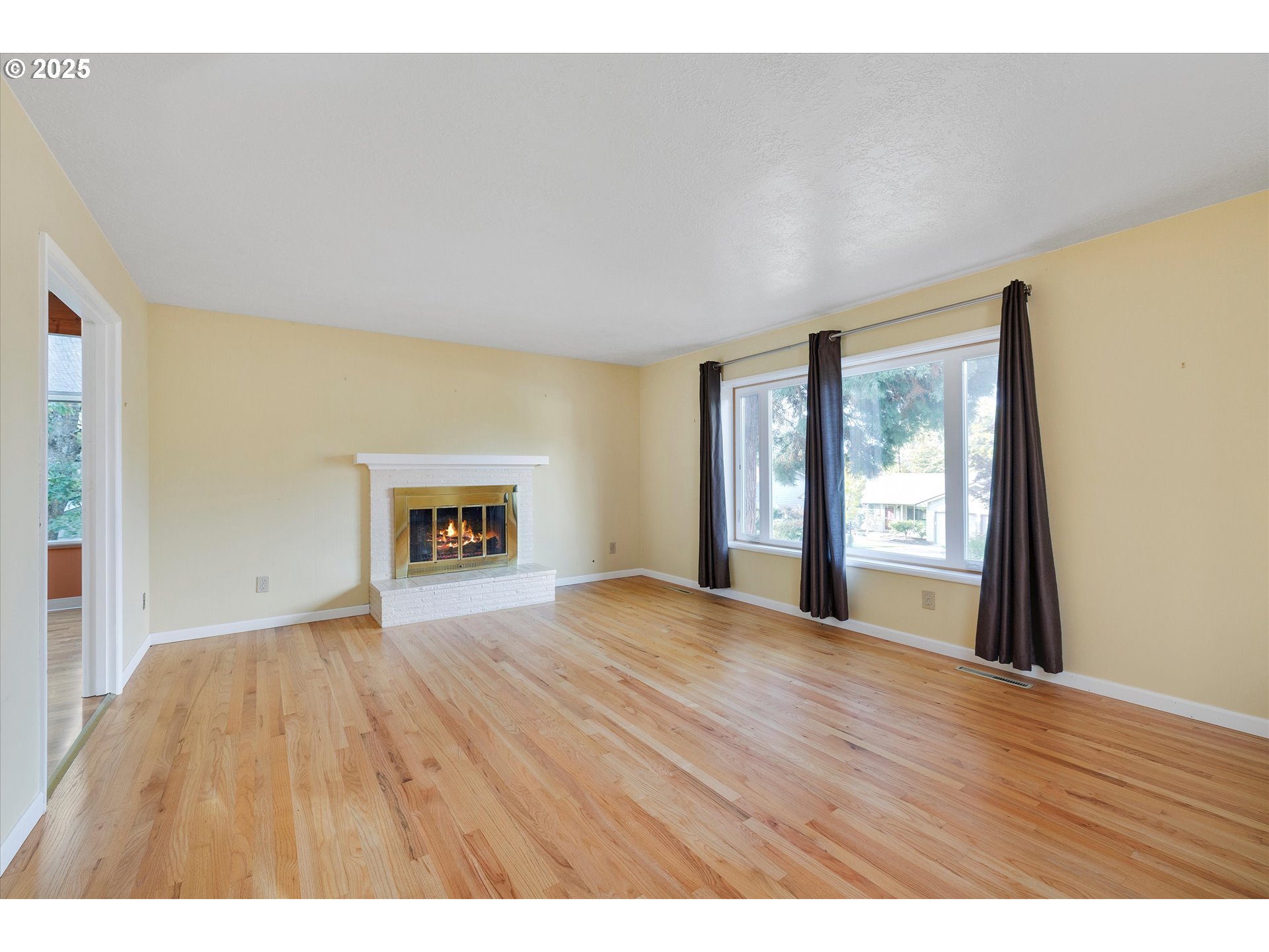 1360 Northwest 130th Avenue Portland, OR 97229 - Photo 10 of 36 a view of an empty room with wooden floor and a window
