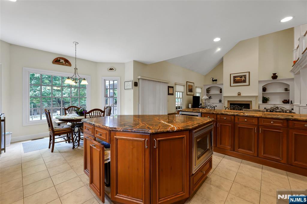 22 Meadowlake Drive Mahwah, NJ 07430 - Photo 15 of 39 a kitchen with stainless steel appliances granite countertop a stove top oven a sink dishwasher and cabinets