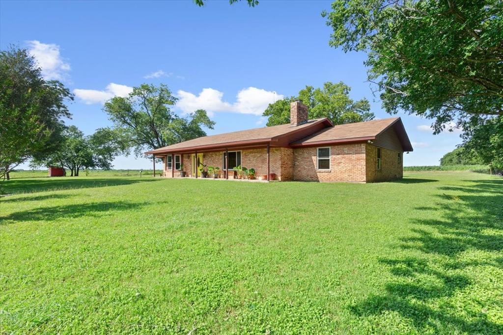 221 County Road 157 Riesel, TX 76682 - Photo 3 of 30 Rear view of property with a chimney and a lawn